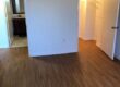 Empty bedroom with wood flooring and closet