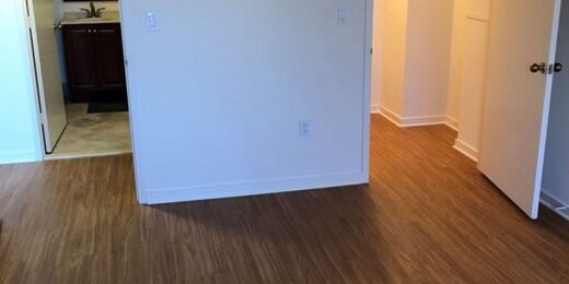 Empty bedroom with wood flooring and closet