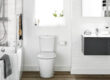 Modern white bathroom with bathtub, toilet, vanity