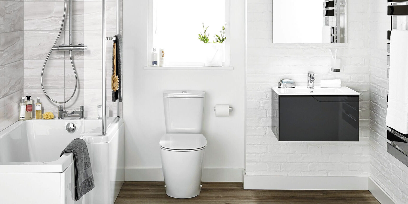 Modern white bathroom with bathtub, toilet, vanity