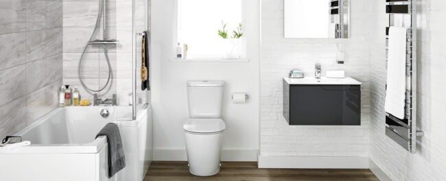Modern white bathroom with bathtub, toilet, vanity
